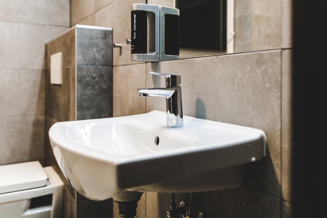 Silesia Residence Ostrava Exterior foto A soap dispenser mounted above a sink